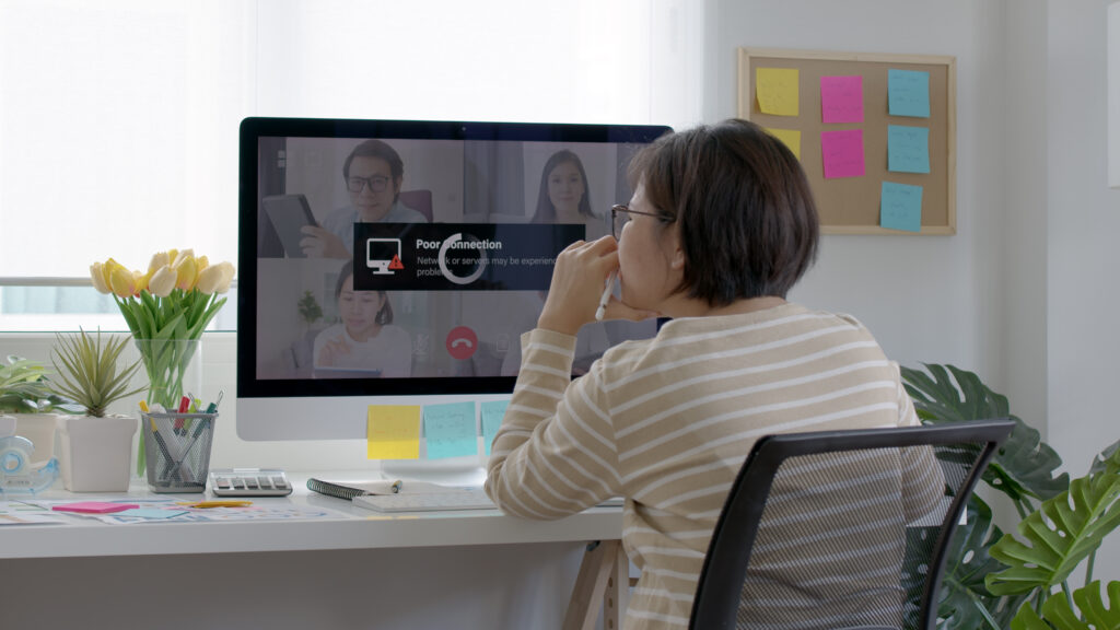 Back view mature middle-aged asian woman employee work from home use computer desktop pc videocall webinar conference angry annoy in low poor unreliable bad wifi connection slow issue outage - 総合経営コンサルタント いなかん